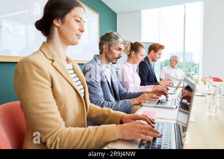 Business team using laptops while working in office Stock Photo