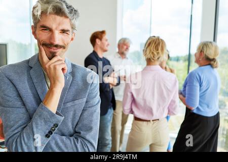 Smiling businessman with mustache wearing blazer at workplace Stock Photo