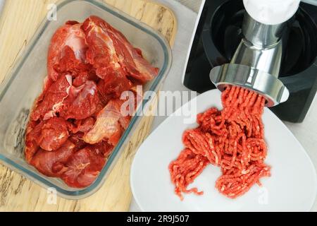 Meat-grinder, grinding fresh meat into minced meat Stock Photo - Alamy