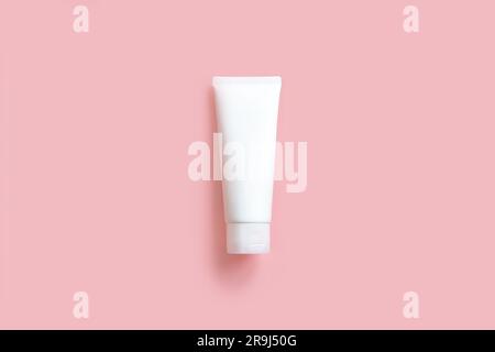 Top view of mockup model of white squeeze bottle cream tube on pink background. Plastic flacon for body lotion, toiletry. Container for cosmetics prod Stock Photo
