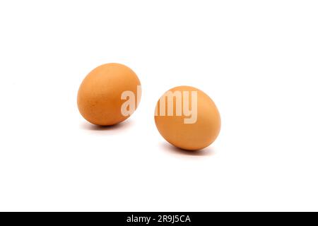 Two brown eggs from a chicken on a white background. Isolated. Photo in high quality. Stock Photo