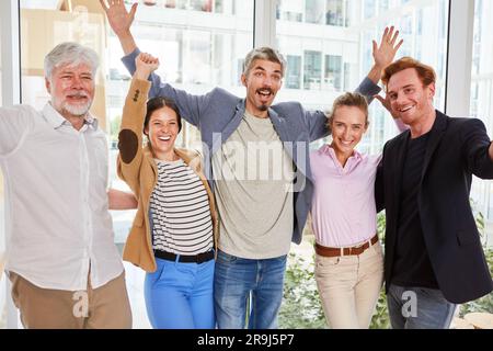 Portrait of cheerful male and female professionals against window Stock Photo