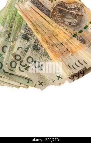 A large stack of Polish 100 and 200 zloty banknotes on a white background.  Synonymous with wealth and abundance. Stock Photo