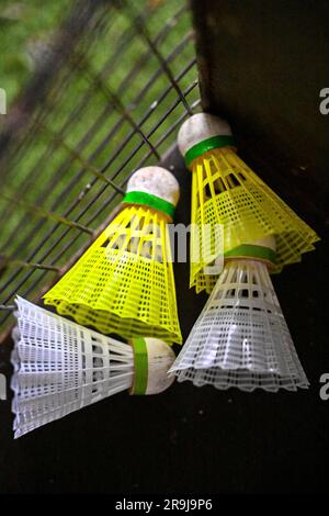Badminton shuttlecock (Birdie) in badminton net outdoors. Background ...