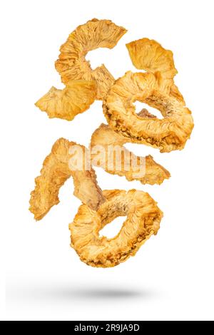 Falling slices of dried pineapple on a white isolated background. Dried pineapple rings of different cuts scatter in different directions. High Stock Photo
