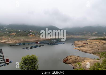 Ta Van, Sa Pa, Vietnam-April 2023; High angle panoramic view of net pens or cages for raising farmed fish, floating in the man-made Seo My Ty Sapa Lak Stock Photo