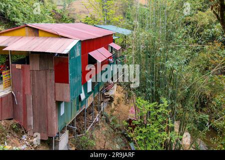Cat Cat Village, Sapa, Vietnam-April 2023; House built on steep slope between bamboo in the traditional village of Cat Cat known for its Water wheels Stock Photo