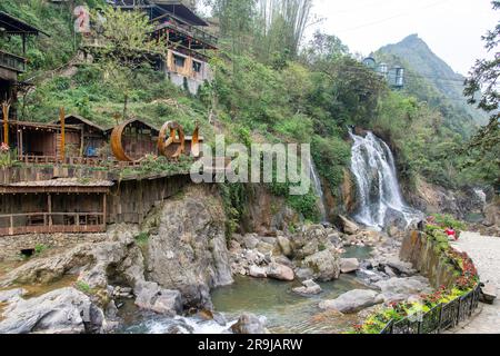 Cat Cat Village, Sapa, Vietnam-April 2023; River and waterfall in the traditional village of Cat Cat known for its Water wheels for power generation a Stock Photo