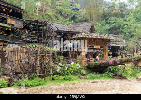 Cat Cat Village, Sapa, Vietnam-April 2023; One water wheel for power generation and made of bamboo and vines and some building in village know for its Stock Photo