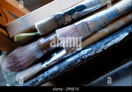 artist paint brushes on easel Stock Photo