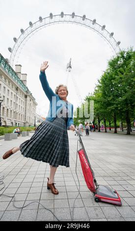 Mrs Doubtfire, played by Gabriel Vick in the musical production in London's West End, prepares to board and give a pod on the lastminute.com London Eye a clean - reenacting the iconic cleaning scene from the 1993 movie. The comedy musical based on the original film is currently playing at the Shaftesbury Theatre in London. Picture date: Tuesday June 27, 2023. Stock Photo