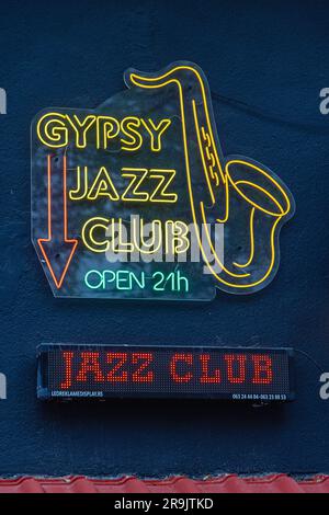 Belgrade, Serbia - May 18, 2023: Neon Sign Gypsy Jazz Club Open 21 Hours at Black Building Wall Kicevska Street in Capital City. Stock Photo