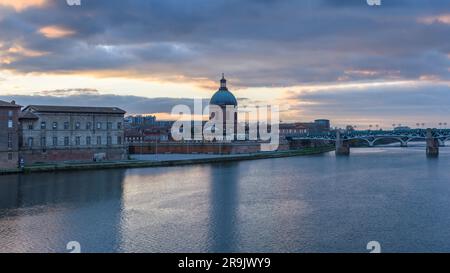 View across the Garonne river to The Hôpital de La Grave hospital, with a dome and bell tower. Stock Photo