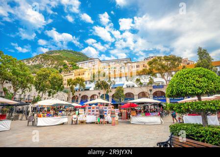 View of Grand Casemates Square. Souvenir market and tourists on main square at sunny day. Gibraltar, Europa Stock Photo