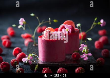 Raspberry mousse cakes with fresh berries and macaroni Stock Photo