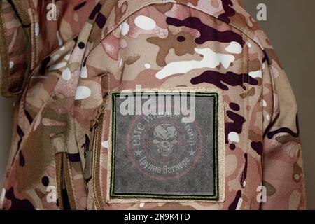 Wagner Group Soldier. Soldier with flag Wagner Private Military Company, PMC Wagner flag on a military uniform. Camouflage clothing Stock Photo