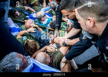 Police officers remove protestors blocking the route of a far right ...