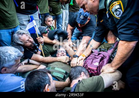 Police officers remove protestors blocking the route of a far right ...