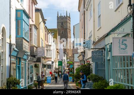 Shops in historic buildings along alleyway with tower of church of St Saviour, Foss Street, Dartmouth, Devon, England, UK Stock Photo