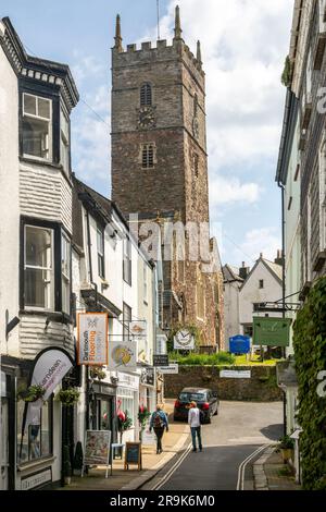 Shops in historic buildings along alleyway with tower of church of St Saviour, Foss Street, Dartmouth, Devon, England, UK Stock Photo