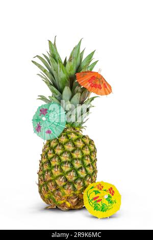 Pineapple with cocktail umbrellas isolated on white background. Stock Photo