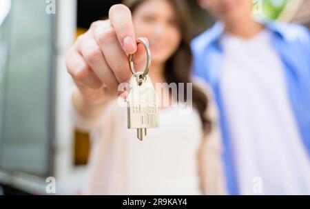 Couple of husband and wife holding key of new house, People spending time together in new house, New life with new home, Happy people celebrating in Stock Photo