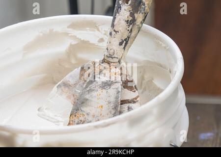 Working with sparkle wall compound spatula human hand construction interior renovation Stock Photo