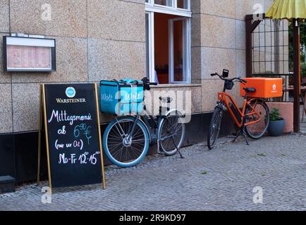 Berlin, Germany. 08th June, 2023. 08.06.2023, Berlin. Messengers from the delivery services Wolt and Lieferando have parked their bikes, both e-bikes, in front of a restaurant in the Steglitz district to deliver food from there. Wolt is a company from Finland, Lieferando belongs to the Dutch company Just Eat Takeaway, which is based in Amsterdam in the Netherlands. Credit: Wolfram Steinberg/dpa Credit: Wolfram Steinberg/dpa/Alamy Live News Stock Photo