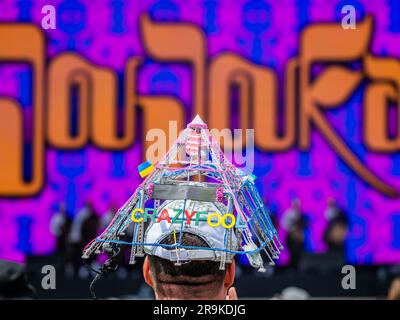 Fans (many already in Elton John outfits incl Alex McGuire and his Elton tribute pyramid stage model hat) watch as Joujouka plays the Pyramid stage - Friday at the 2023 Glastonbury Festival, Worthy Farm, Glastonbury. Stock Photo