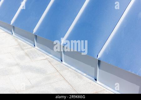 Abstract architecture background photo with new shiny roof made of stainless steel plates and stone floor tiling Stock Photo