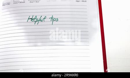 Helpful tips, handwriting text on page of office agenda. Copy space. Stock Photo