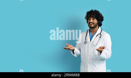 Smiling indian doctor have online appointment with patient, using headset Stock Photo