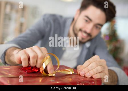 happy man under christmas tree with presents Stock Photo