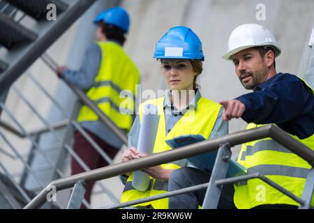 team of architects and civil engineers inspecting site Stock Photo