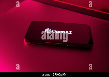 Azores, Portugal - 21.01.2023: SmartPhone with OpenAI Logo with red light color effect. Stock Photo