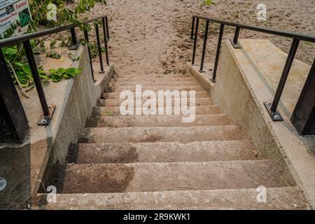 stairs leading down to a sandy beach Stock Photo