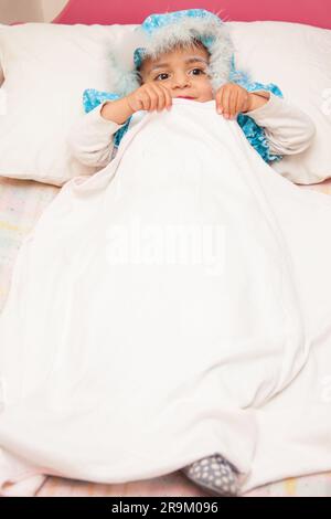 Little girl on grandma costume. Real family having fun while using