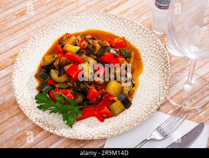 Plate of stewed vegetables on table. Vegetarian dish Stock Photo