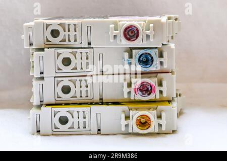 Closeup of the underside of 4 empty inkjet cartridges with magenta, light cyan, yellow, and light magenta colors Stock Photo