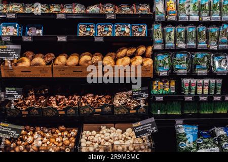 Mushrooms and herbs on shelves at Metropolitan Market upscale grocery store in Seattle, WA Stock Photo