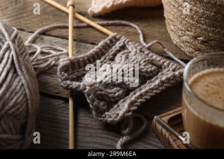 Soft grey woolen yarn, knitting and needles on wooden table, closeup Stock Photo