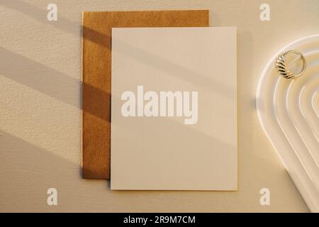 Blank paper mock-up in natural sunlight, top view. Minimalist composition Stock Photo