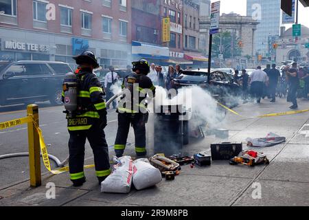 New York, USA, June 27, 2023, FDNY fire officials inspect an e-bike repair shop in Manhattan Chinatown in search of defective and unsafe Li-ion batteries. Pictured: NYC Fire Commissioner Laura Kavanagh and other city officials watch as firefighters quench a fire caused by a lithium ion electric bike battery that was accidentally punctured during disposal causing a short circuit. Recent deaths from the June 20th fire at an e bike shop on Madison St--on top of multiple other fires this year blamed on electric bike batteries across the city--has spurred the city toward increased enforcement. Stock Photo