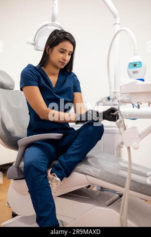 dental office interior with medical instruments for patient care, healthcare professional lifestyle, dentist at workplace, woman in uniform Stock Photo