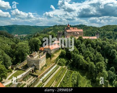 Aerial view of Pernstejn castle with Gothic palace red roof, rectangular and round towers, barbican, forward gun platform in Moravia Stock Photo