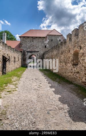 Aerial view of Pernstejn castle with Gothic palace red roof, rectangular and round towers, barbican, forward gun platform in Moravia Stock Photo