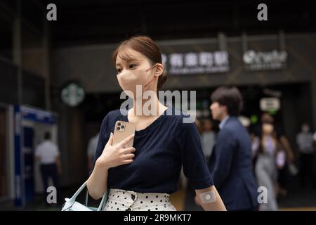 Tokyo, Japan. 27th June, 2023. A young woman exits Yurakucho station in central Tokyo. Credit: SOPA Images Limited/Alamy Live News Stock Photo