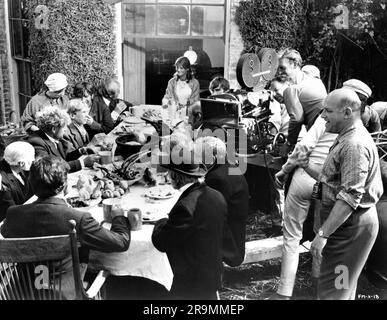 ALAN BATES (back to camera) JULIE CHRISTIE Director JOHN SCHLESINGER and Movie / Film Crew on set location candid during filming of FAR FROM THE MADDING CROWD 1967 director JOHN SCHLESINGER novel Thomas Hardy screenplay Frederic Raphael cinematographer Nicolas Roeg Vic Films Productions / Metro Goldwyn Mayer Stock Photo