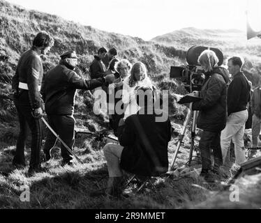 TERENCE STAMP Director JOHN SCHLESINGER and JULIE CHRISTIE on set location candid with Movie / Film Crew during filming of FAR FROM THE MADDING CROWD 1967 director JOHN SCHLESINGER novel Thomas Hardy screenplay Frederic Raphael cinematographer Nicolas Roeg Vic Films Productions / Metro Goldwyn Mayer Stock Photo