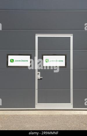 John Deere logo on the door and building exterior at the John Deere landscaping and grounds care equipment dealership. Salo, Finland. June 25, 2023. Stock Photo